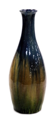 A large early 20thC Belgian pottery bottle vase, with blue, brown and green running glazes, 49cm high.