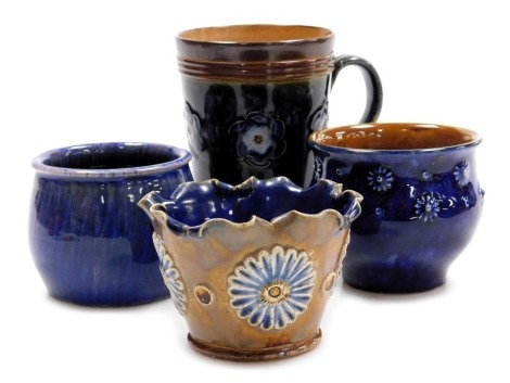 Royal Doulton and Langley pottery, comprising a Royal Doulton stoneware mug, with green mottled glazed and blue flower heads, within brown banded borders, 13.5cm high (AF), a small stoneware bowl with blue glaze and flower head prunts, with impressed mark