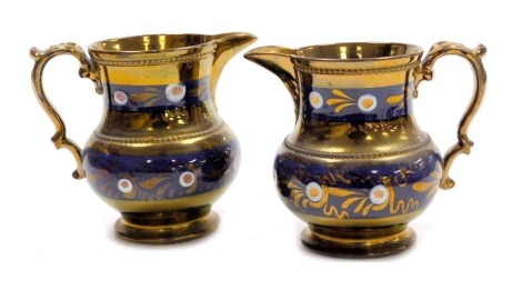 Two Victorian copper lustre brown earthenware jugs, with blue banded decoration, and beaded borders, with scroll handles, 14cm high.