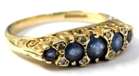 A 9ct gold and sapphire five stone ring, in a graduated design, with pairs of diamonds at intervals, size O, 3.2g.