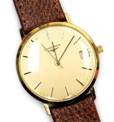 A Longines gentleman's gold plated wristwatch, circular gilt dial, centre seconds, date aperture, stainless steel back, number 19282452, on a leather strap.