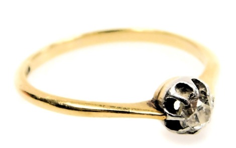 A diamond solitaire ring, claw set with a rose cut diamond, in yellow and white metal, stamped 18ct, approximately ¼ct, size N, 2.0g.