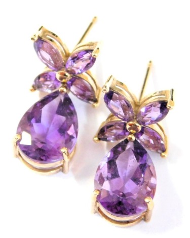 A pair of amethyst earrings, of flower and teardrop form, set in yellow metal, stamped 10k, 2.2g.