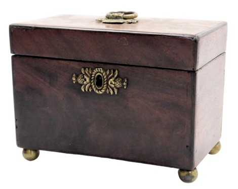 A George III mahogany tea caddy, with brass carrying handle and key escutcheon, opening to reveal twin lidded compartments, raised on brass ball feet, 18cm wide.