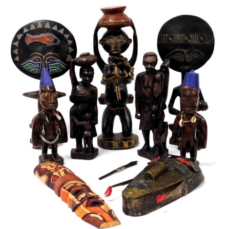 A group of African trible carvings, some with beadwork, comprising four fertility figures, three further figures, and two masks. (9)