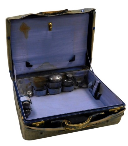 An Edward VII blue leather travelling case, containing four cut glass bottles with silver lids, monogram engraved, and a silver rouge pot, London 1907.