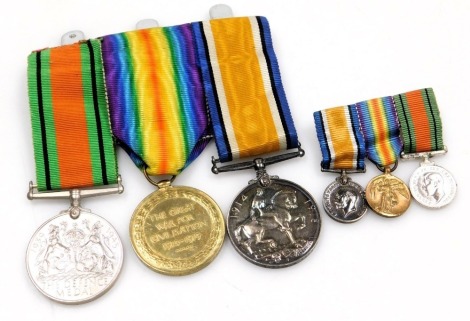 A WWI and WWII medal group, comprising 1914-18 British War Medal, Victory Medal and 1939-45 Defence Medal, the WWI medals inscribed to 512299 Bmbr JE Wild Royal Artillery, and a miniature group to match.