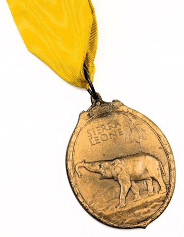 A George VI Sierra Leone Medal, inscribed George VI King and Emperor, with crown hanger, the obverse inscribed Sierra Leone with elephant in a landscape, with Moire silk ribbon.