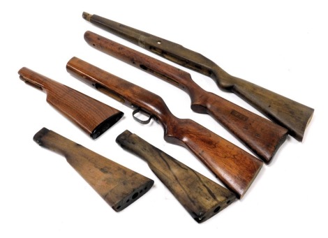 Rifle stocks and gun butts, including an example stamped Rifle Stock, two other stained beech rifle stocks, andthree various butts.