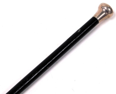 A plain ebonised walking cane, with silver capped handle, hallmarked for London 1930, 91cm long.