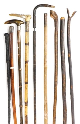 Canes and sticks, including a horn handled bamboo walking stick with silver mount, initial W Hodson, walking stick with silver capped handle, hazel thumb stick, other walking sticks, and a leather bound whip. (9)