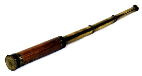 A 19thC three draw brass telescope, with mahogany grip, brass lens cap, 39.5cm long fully extended.