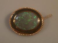 An 18ct gold opal set oval brooch