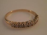 An 18ct gold diamond set half eternity ring