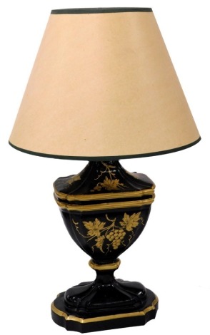 A Regency Toleware style ceramic table lamp, gilt decorated with vines on a black ground, with shade, 69cm high.