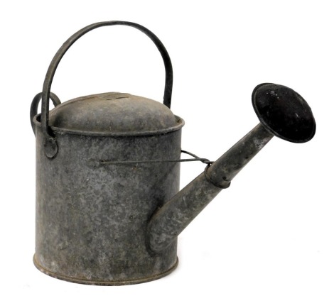 A vintage galvanised watering can, 50cm wide.