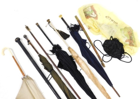 A group of Victorian and later parasols and umbrellas, together with an ebony walking stick, 99cm long, and a scarf showing a map of Cyprus.