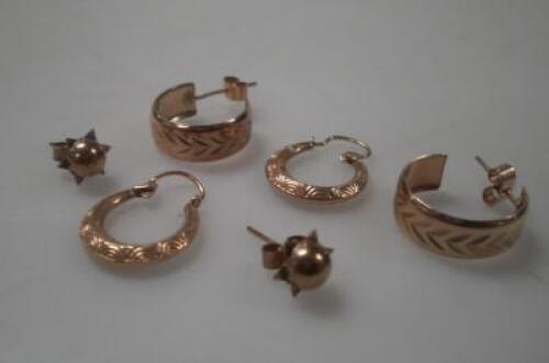 Three pairs of yellow metal earrings