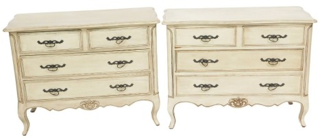 A pair of French style cream painted commodes, each of two short over two long drawers, raised on cabriole legs, 85cm high, 108cm wide, 50cm deep.