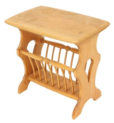 An Ercol Chaucer light elm magazine rack side table, raised on trestle end supports, 50cm high, 54cm wide, 36cm deep.