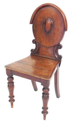 A Victorian mahogany hall chair, with an oval back, carved with a shield, solid seat, raised on turned legs, 43cm wide.