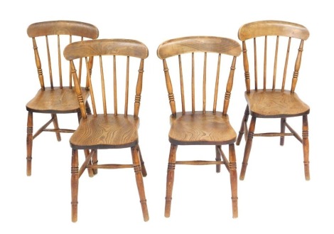 A set of four Victorian oak and elm spindle back kitchen chairs, with solid saddle seats, raised on turned legs united by a h frame stretcher.