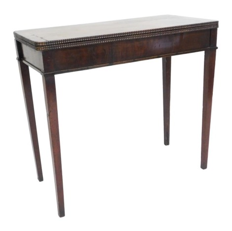 A Georgian mahogany demi-lune fold over card table, raised on tapering square legs, 74cm high, 82cm wide, 40cm deep.