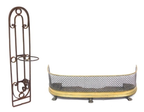 A Victorian brass and mesh bedroom fender, raised on lion's paw feet, 84cm wide, together with a cast iron urn holder, 91cm high. (2)