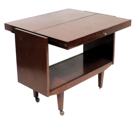 A mid century mahogany hostess trolley, with a central shelf/half table top, raised on tapering square legs on castors, 73cm high, 88cm wide, 38.5cm deep.