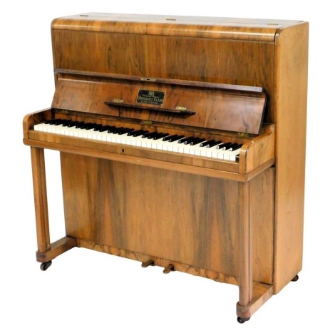 A small walnut upright piano, label for Cestrian model, Herbert Ellis, Chester, with simulated ivory keys on plain end supports, 107cm wide.