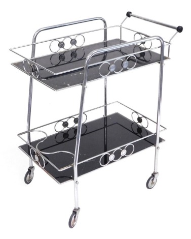 A 1970s chrome and glass two tier serving trolley, on castors, 70cm wide.