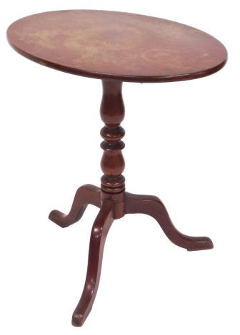 A Victorian mahogany tilt top occasional table, the oval top raised on a baluster turned column over three cabriole legs, 71cm high, 68cm wide, 47cm deep.