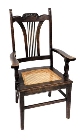 A Victorian oak carver chair, with a foliate carved crest rail, cane seat, raised on tapering square legs, 66cm wide.