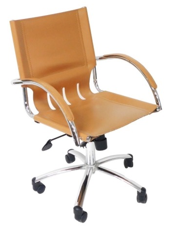 An Eames style tan leather swivel chair, raised on a five prong base, on castors, 56cm wide.