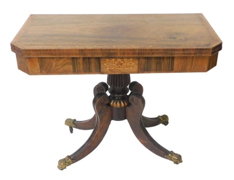 A Regency rosewood and inlaid fold over card table, the cross banded top with a band of repeating flowers, the frieze with flowers, raised on a fluted and turned column over four outswept legs, brass capped on castors, 72cm high, 91cm wide, 45.5cm deep.