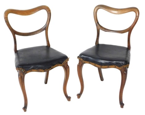 A pair of Victorian rosewood dining chairs, upholstered in black leatherette, raised on cabriole legs.