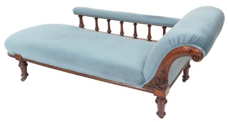 A Victorian mahogany chaise longue, upholstered in button back light blue draylon, raised on turned legs, on castors, 192cm wide.