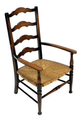 An oak ladder back low chair, with cane seat, raised on turned legs, 51cm wide.