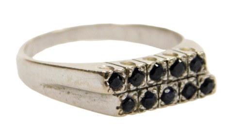 An 18ct white gold and sapphire ring, set with ten sapphires, in an unaligned two row setting, size P, 5.7g.