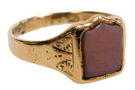 A lady's 12ct gold and sardonyx signet ring, with a shield shaped table, and foliate engraved shoulders, size R, 3.7g.