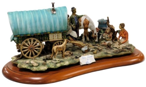 A Capodimonte porcelain figure group modelled as Gypsy Caravan, by Cortese, raised on a wooden base, 66cm wide.