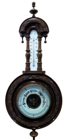 A Victorian oak cased aneroid barometer, with ceramic backed thermometer, the case carved with oak leaves, 71cm high.