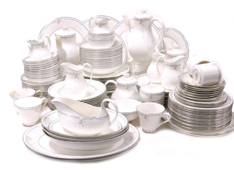 A Royal Doulton Carnation pattern dinner tea and coffee service, including serving bowls, pair of meat platters, sauce boat on stand, tea and coffee pots, dinner, dessert, side and soup plates, fruit bowls, etc. (qty)