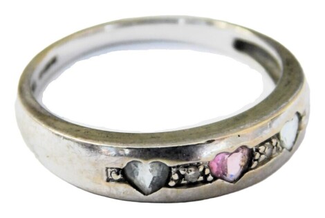 A 9ct white gold band, set with three heart shaped coloured stones, flanked by diamonds, size N, 2.2g.