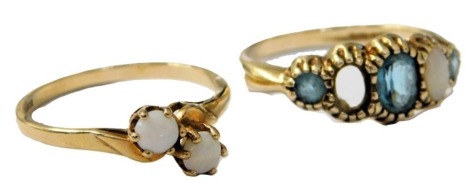 A 9ct gold and opal two stone ring, in a crossover design, size N, and a 9ct gold, aquamarine and opal five stone ring, one opal lacking, size N, 3.7g.