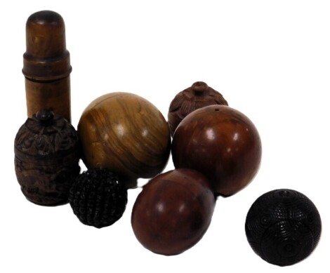 A group of treen, including eggs, carved containers, a phial holder, and a treen puzzle snuff box. (7)