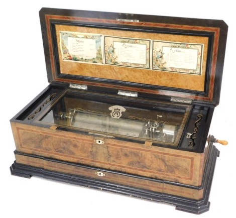 A late 19thC Swiss walnut and ebonised cased music box, with bone escutcheons, playing eighteen aires, the case with mother of pearl inlay, kingwood crossbanding and boxwood line inlay, 95cm wide.