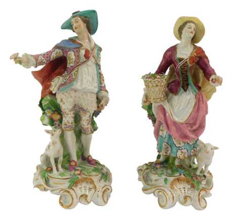 A pair of 19thC French porcelain figures, modelled as a lady holding a flower basket beside a sheep and a gallant holding a flower with a seated dog beside, each encrusted with flowers, gilt heightened, 32cm high. (hat on lady AF)