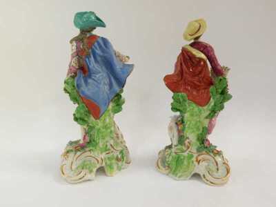 A pair of 19thC French porcelain figures, modelled as a lady holding a flower basket beside a sheep and a gallant holding a flower with a seated dog beside, each encrusted with flowers, gilt heightened, 32cm high. (hat on lady AF) - 2