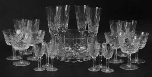 A part suite of Waterford Crystal Lismore pattern glasses, comprising four champagne flutes, six sherry glasses, six cocktail glasses, six liqueur glasses, and a salad bowl.